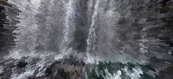 A digitally altered image creates a dynamic, pixelated effect resembling an abstract waterfall with cascading shapes and shades. The presentation is visually striking, turning an otherwise photographic scene into an intriguing piece of digital artwork.