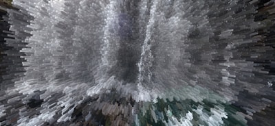A digitally altered image creates a dynamic, pixelated effect resembling an abstract waterfall with cascading shapes and shades. The presentation is visually striking, turning an otherwise photographic scene into an intriguing piece of digital artwork.