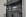 A server rack containing various network and power management devices. The devices feature buttons, switches, and digital displays, indicating active usage and monitoring capabilities. The rack has a black metal mesh design for ventilation.