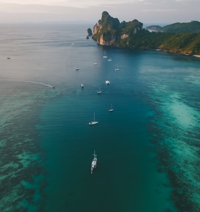 white boats on ocean water under gray sky