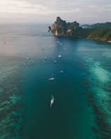 white boats on ocean water under gray sky