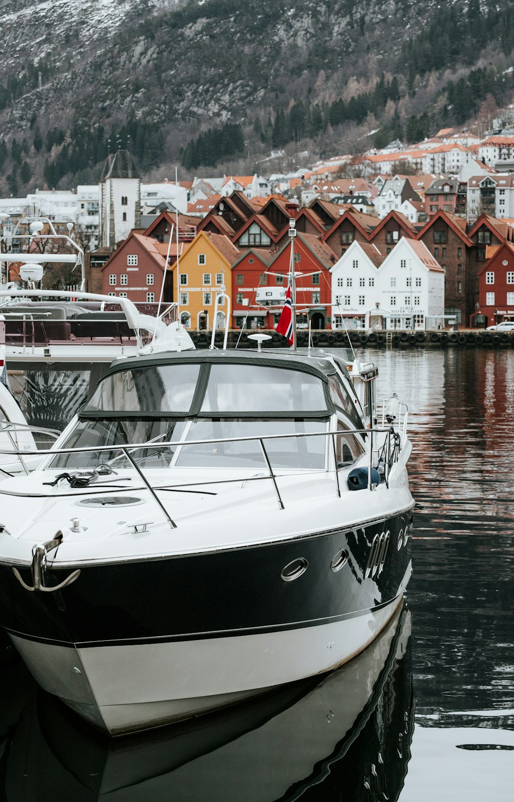 black and white boat docking near houses