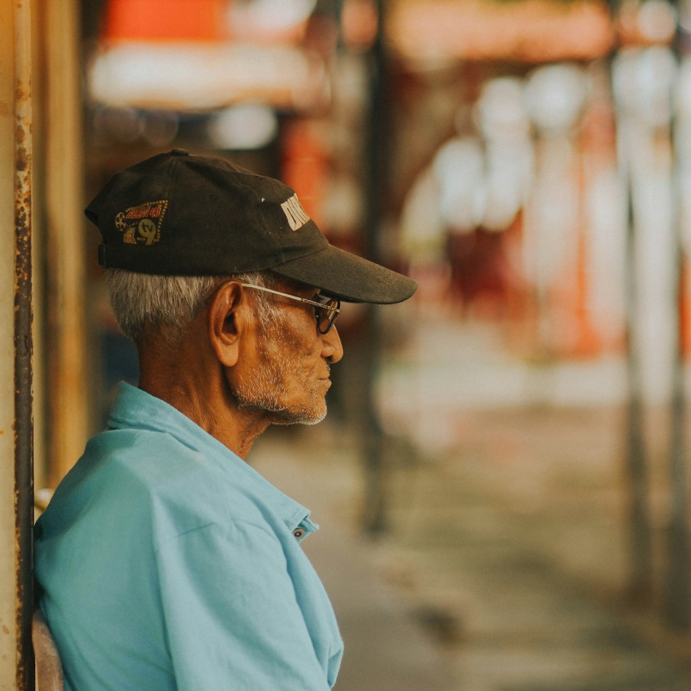 man leaning on wall