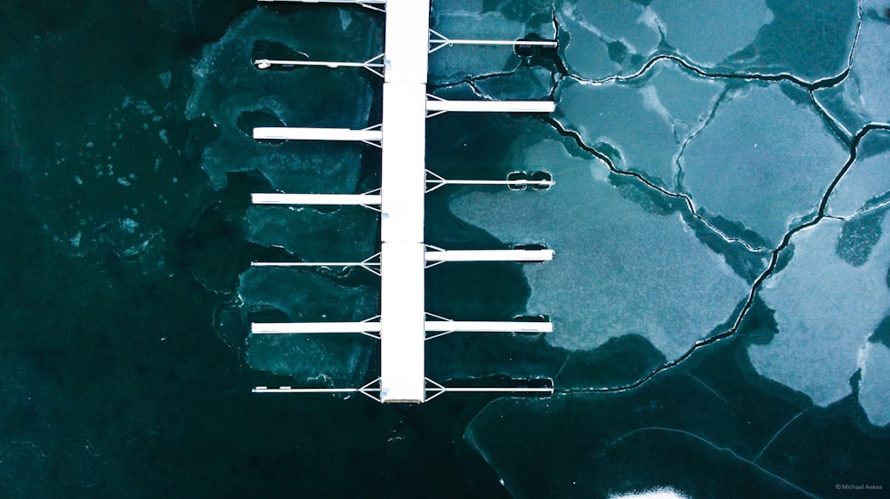 an aerial view of a dock in the water