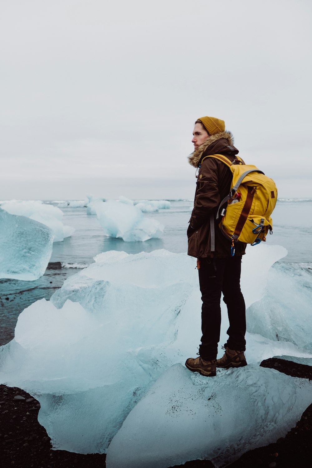 man standing on ice rack under gray sky