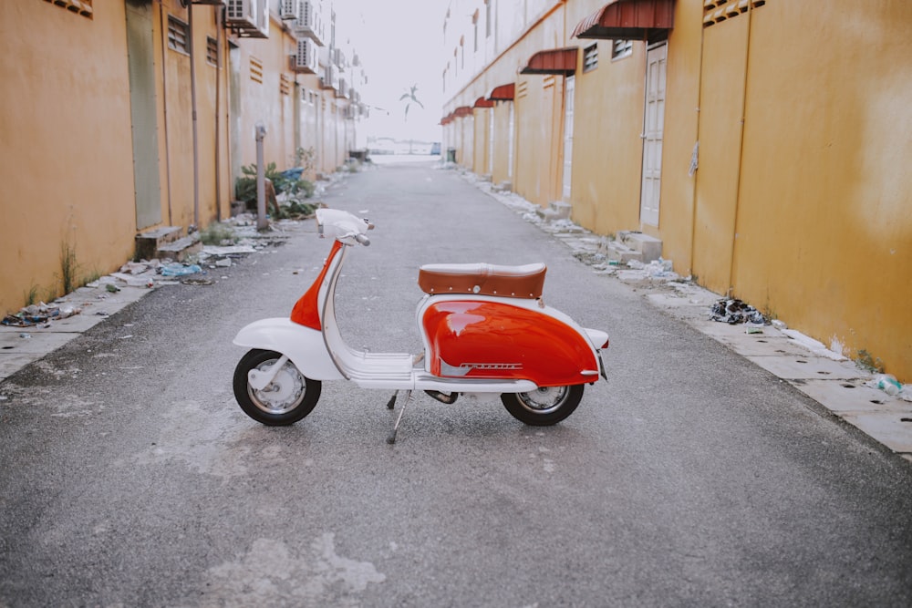 red and white motor scooter