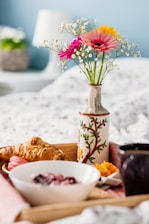 three assorted-color petaled flowers in vase on serving tray