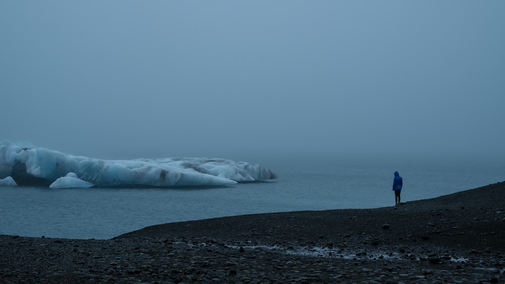 man standing on green mountain