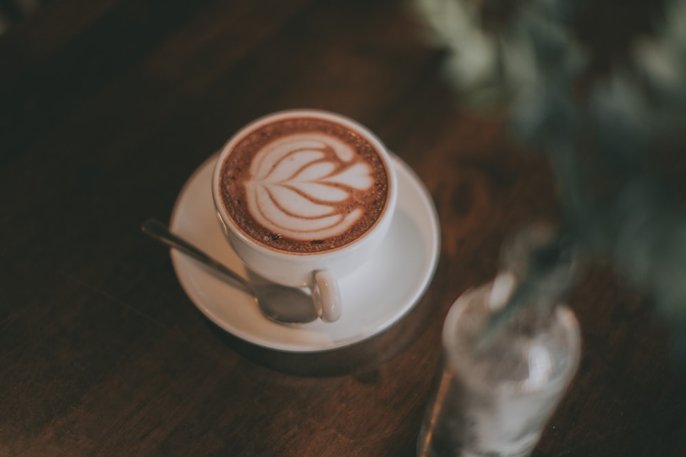 white ceramic coffee cup with saucer