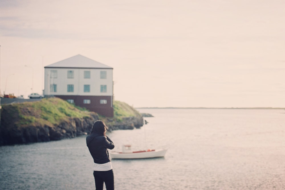 woman standing near body of water w