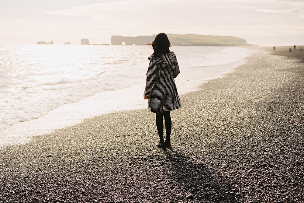 women wearing white long-sleeved shirt on seashore