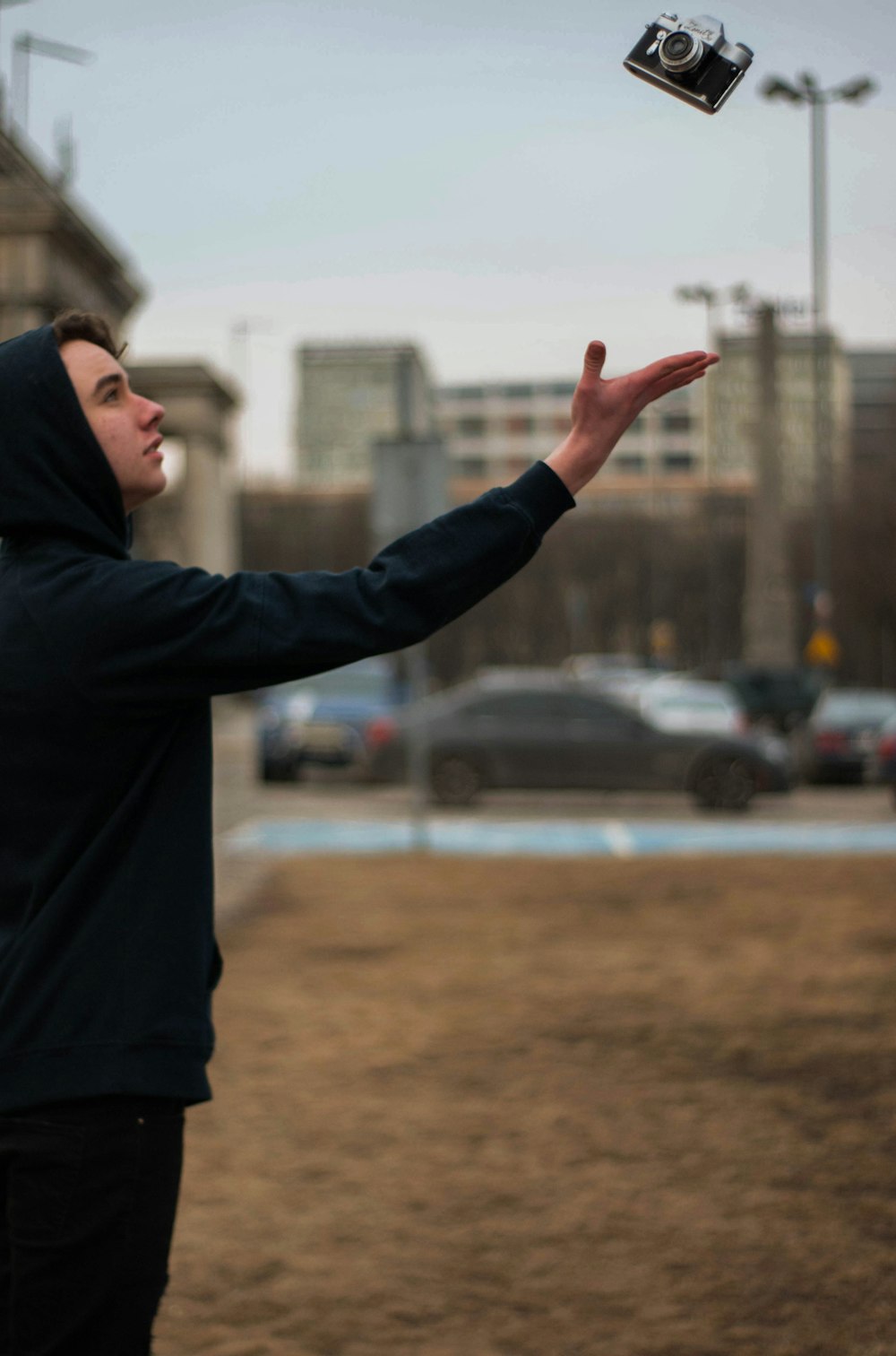 selective focus photography of man reaching for black bridge camera