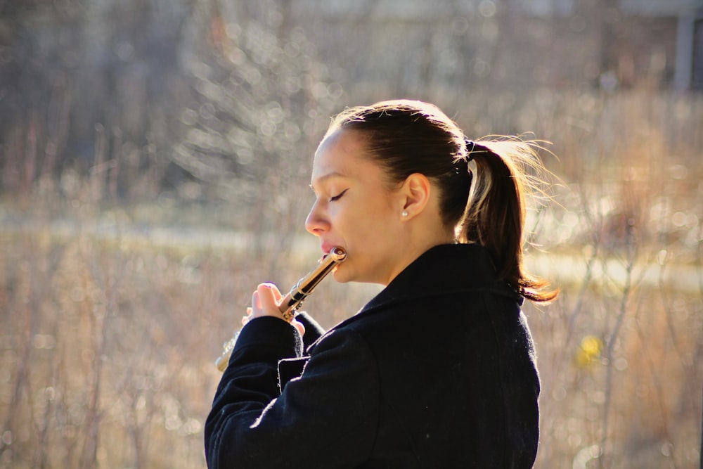 woman playing flute on fields