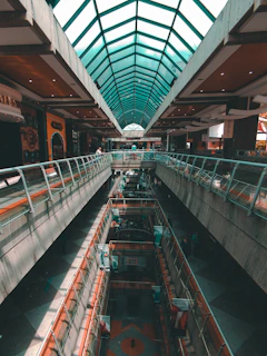 Wide shot of the mall’s modern interior with bright orange and teal accents