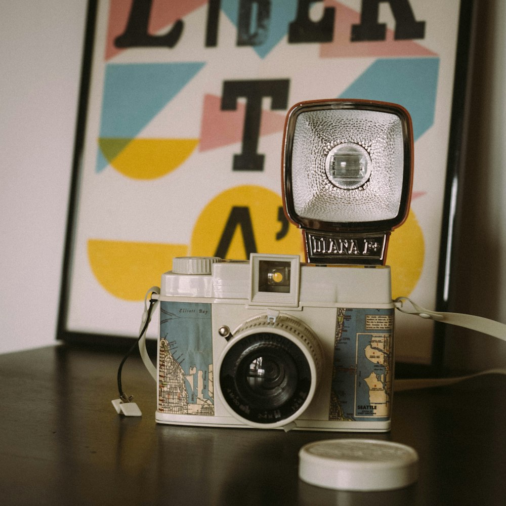 white and green camera on table