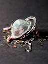selective focus photography of round silver-colored accessory