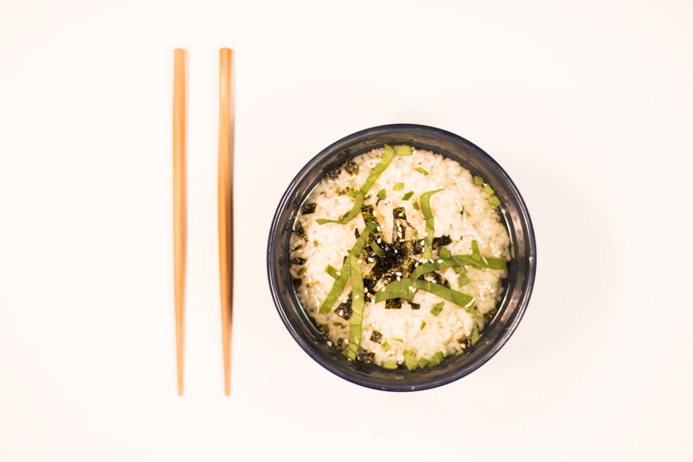 bowl of noodles with pair of chopstick beside