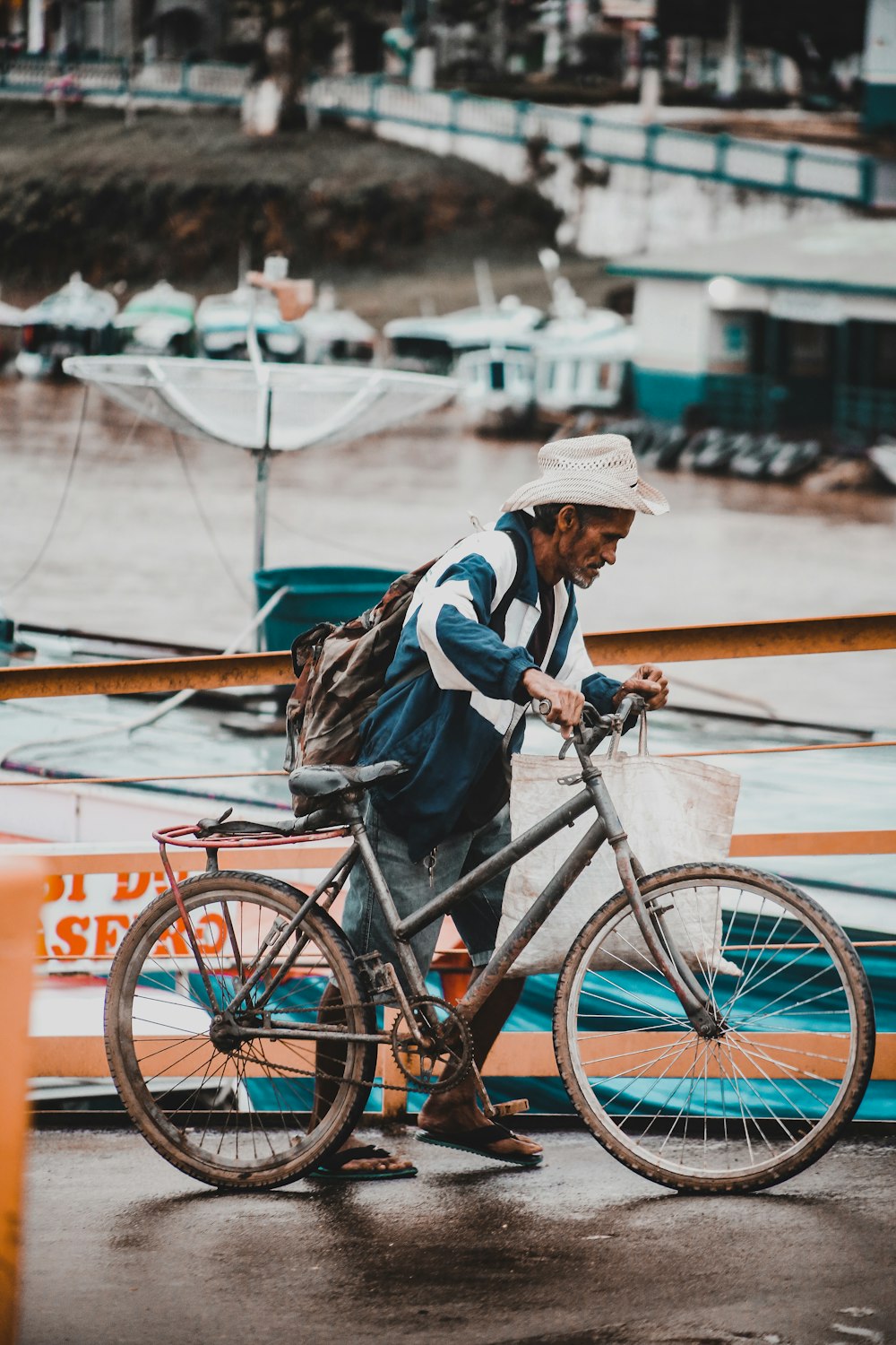 海の近くで自転車を持っている男