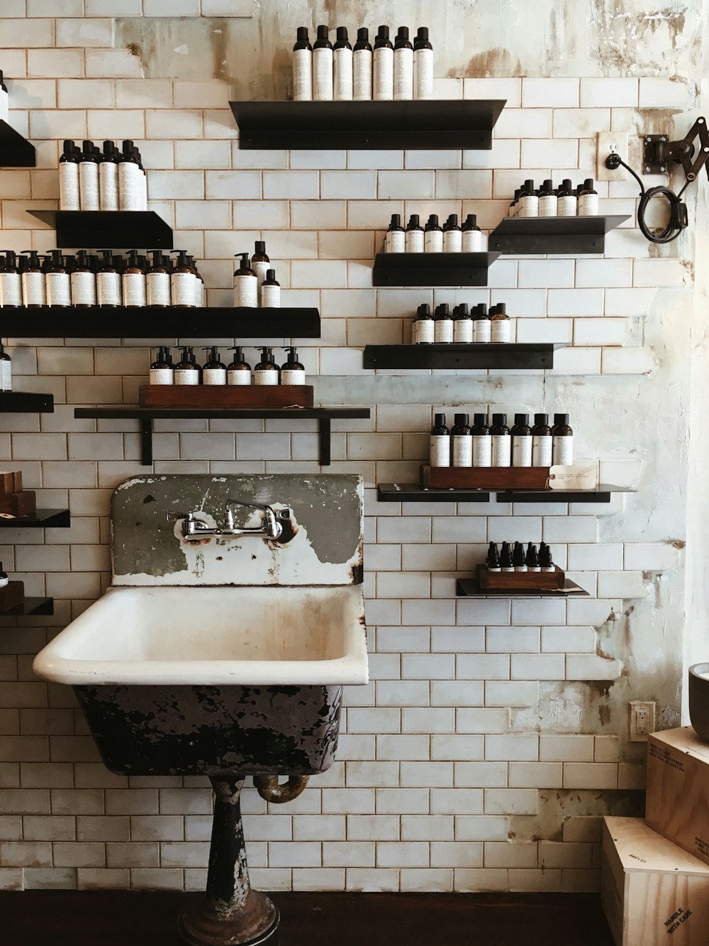 bottles on wall shelves above sink