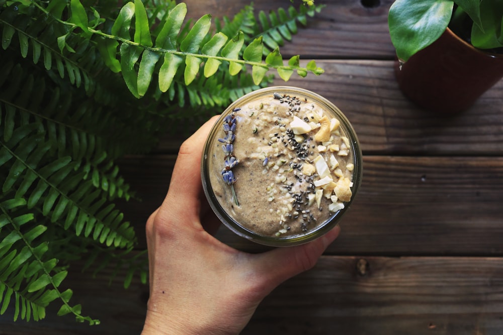 person holding a glass of smoothie