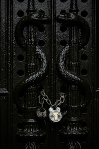 gray chain padlock on door in closeup shot