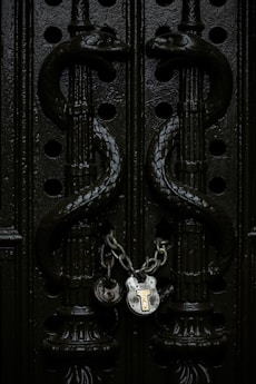 gray chain padlock on door in closeup shot