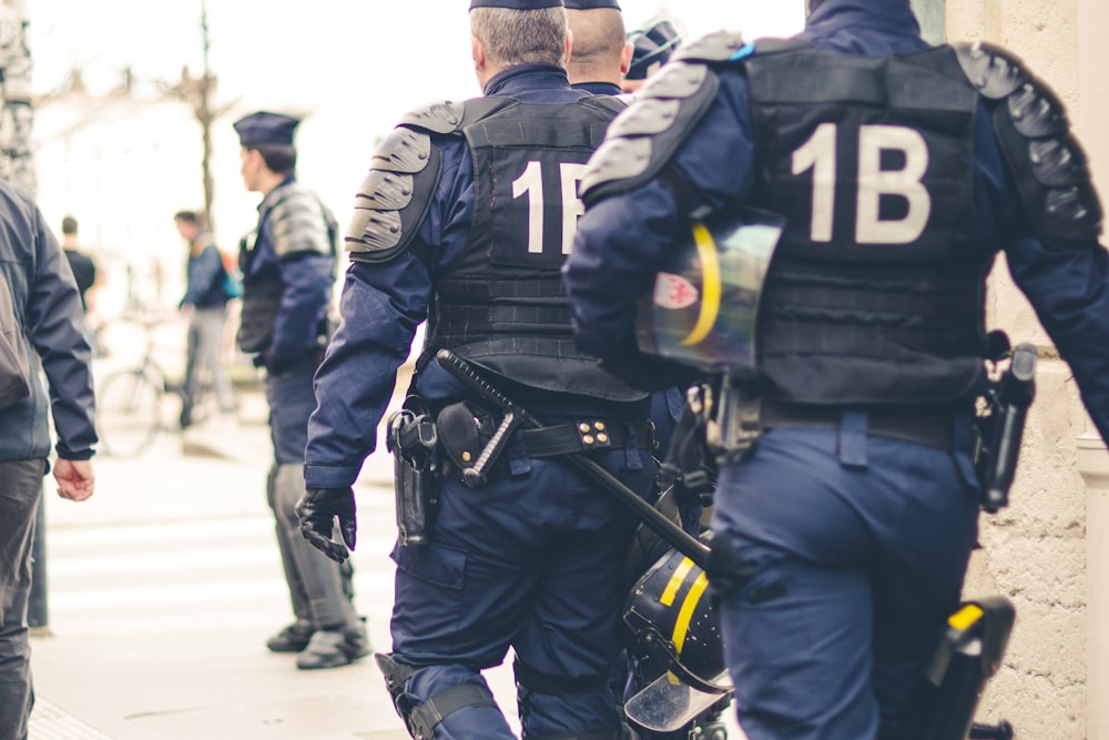 group of police officers walking during daytime