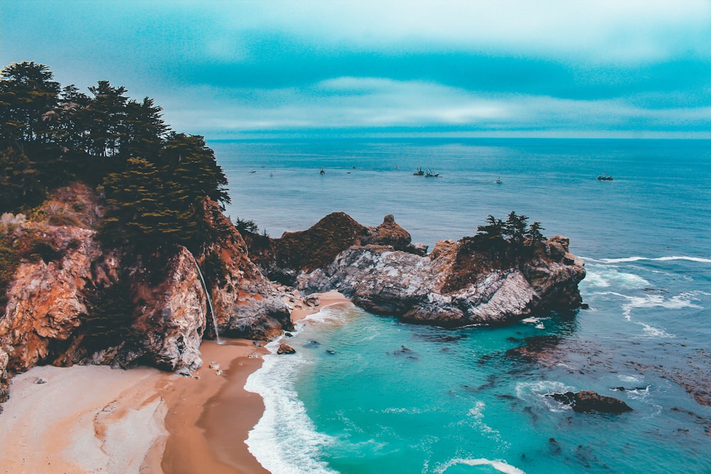 aerial photography of island under white clouds