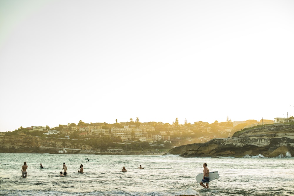 people swimming on beach