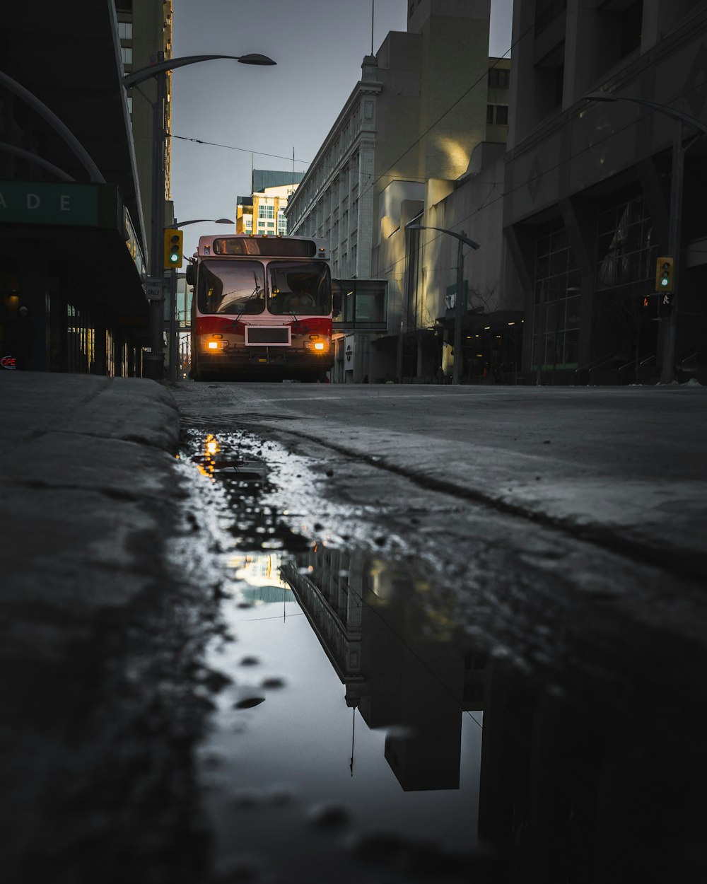 bus on road near white high-rise building