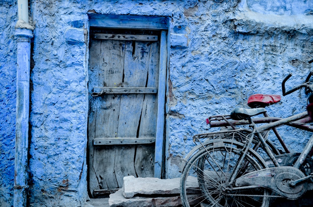 two bicycles beside blue concrete structure