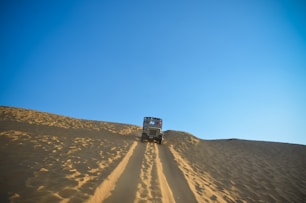 white car travelling on desert