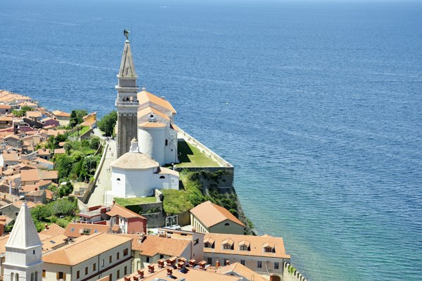 White and brown concrete house near body of water — Piran, Slovenia