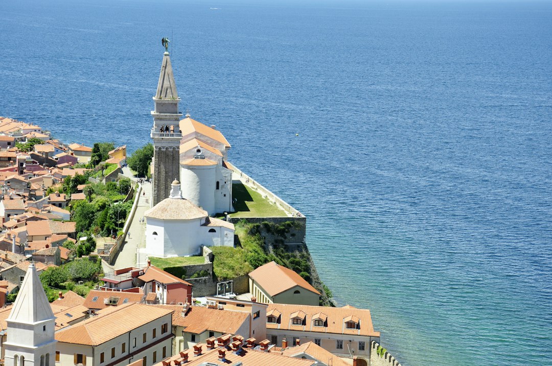 white and brown concrete house near body of water, View to Izola in Slovenia