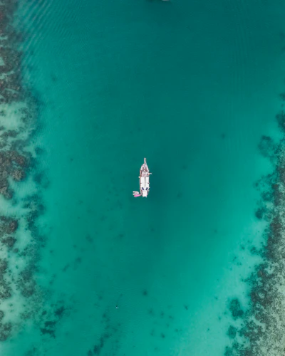 The excursion boat anchored over turquoise water