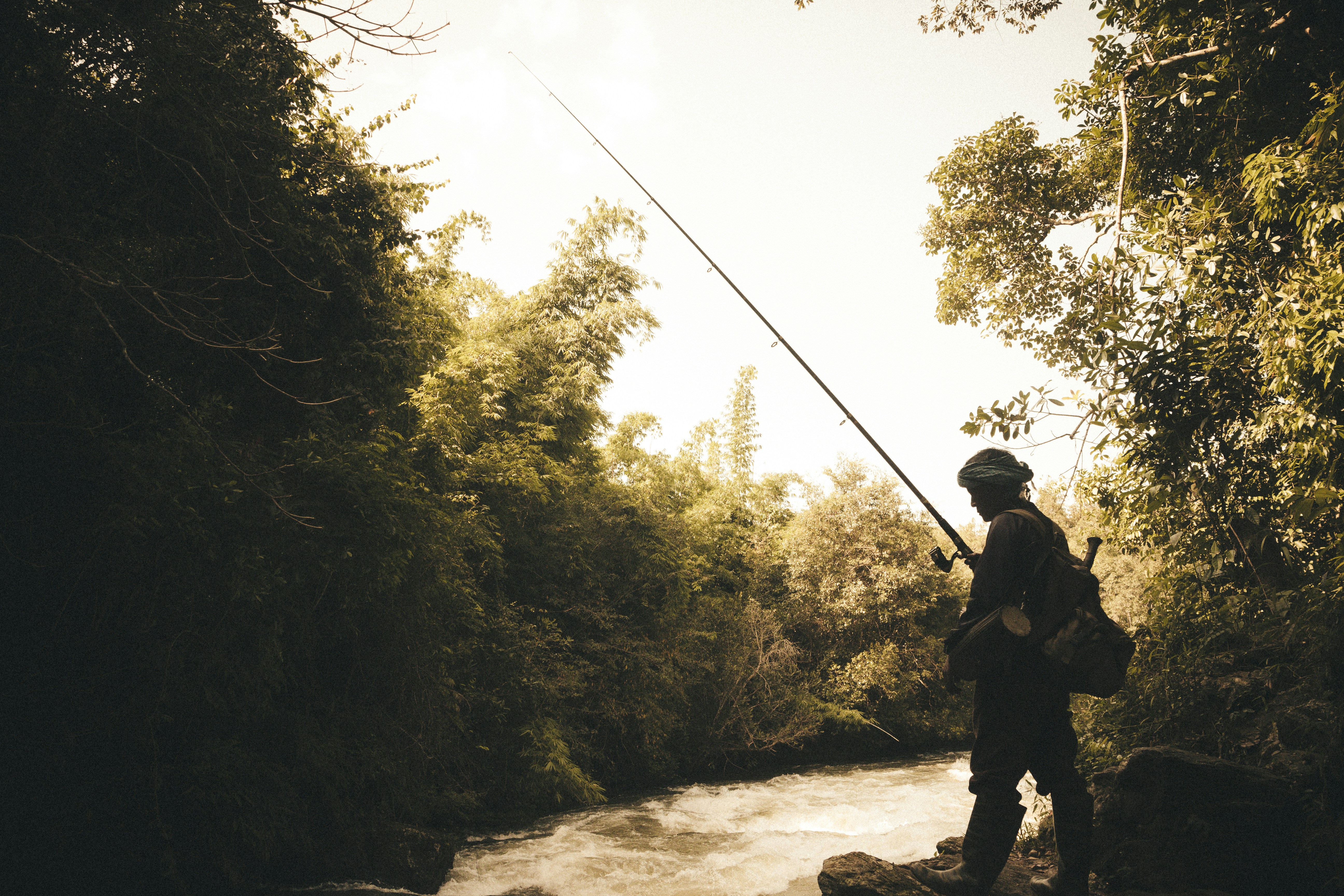 man fishing on river