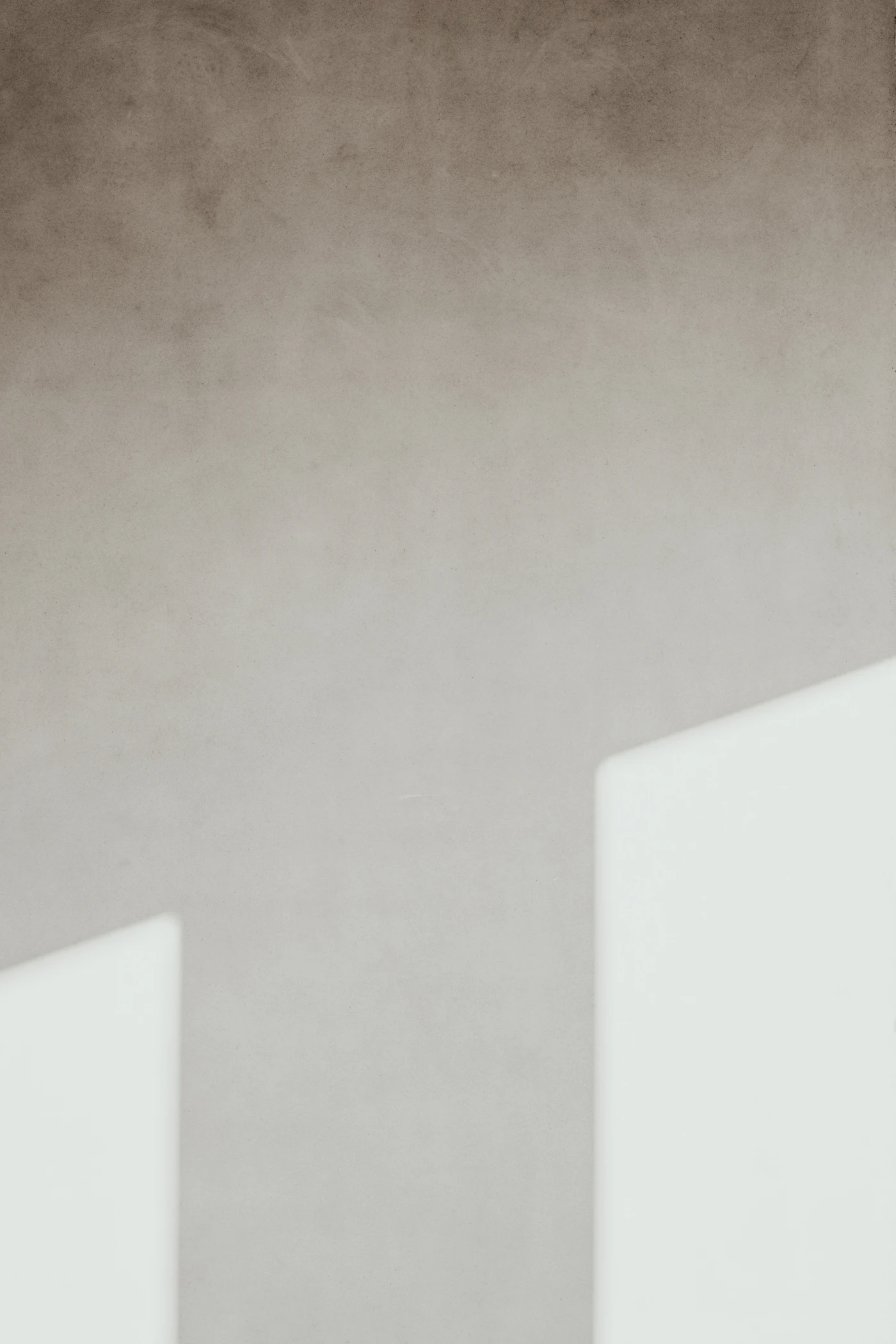 Sunlight raking across the plaster walls of Maison Héliotrope