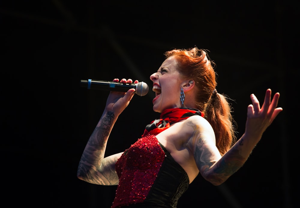 woman singing on wireless microphone