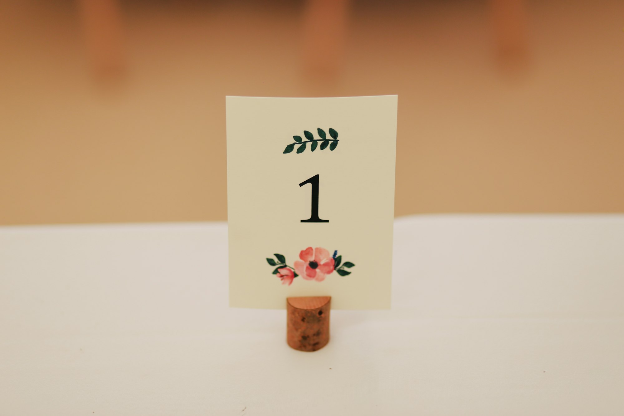 A wedding table number placard, showing the number 1.