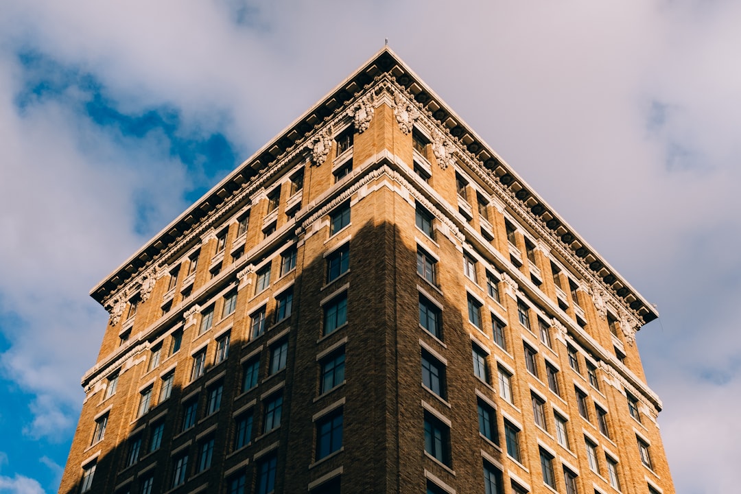 low angle photography of building under cloudy sky at daytime