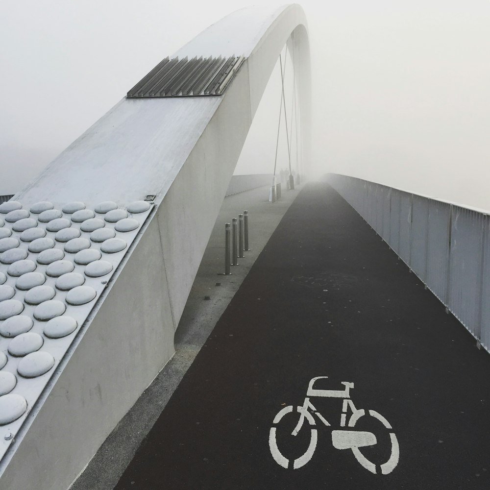 black bicycle lane on a bridge