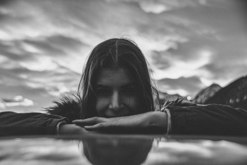 a woman with long hair standing in the water