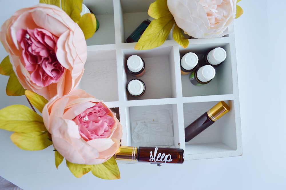 several vials in white wooden organizer shelf