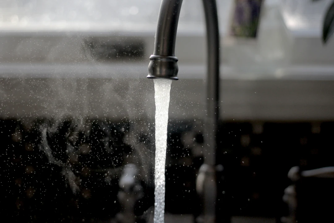 Water running from a black kitchen faucet