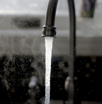 a faucet running water from a kitchen sink