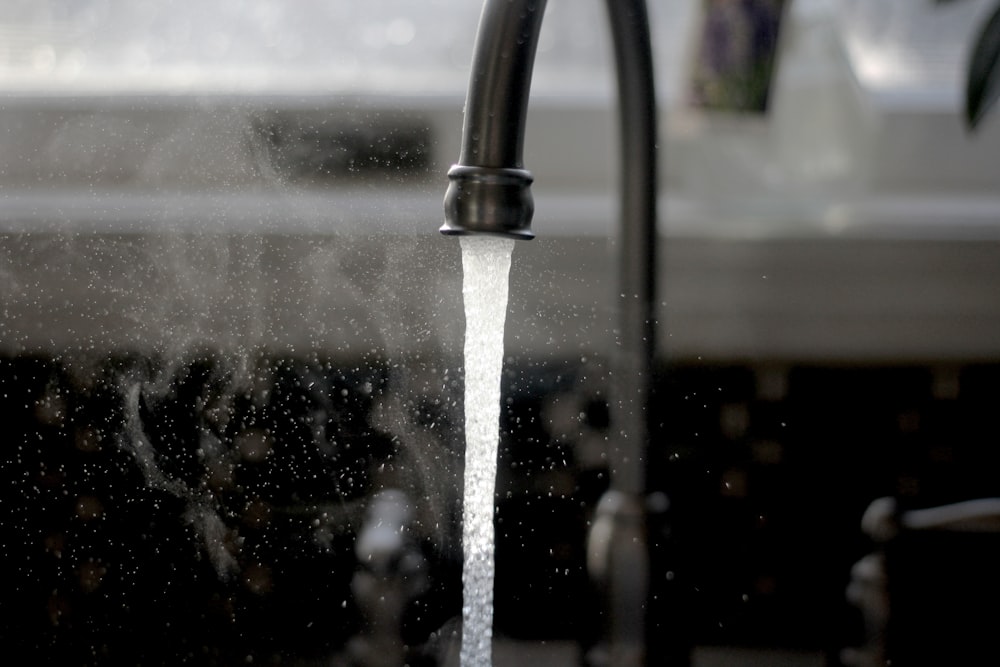 a faucet running water from a kitchen sink