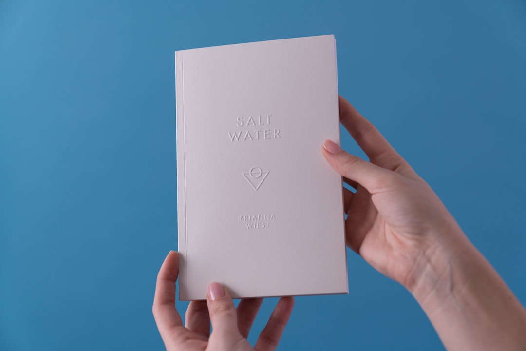 person holding Salt Water book