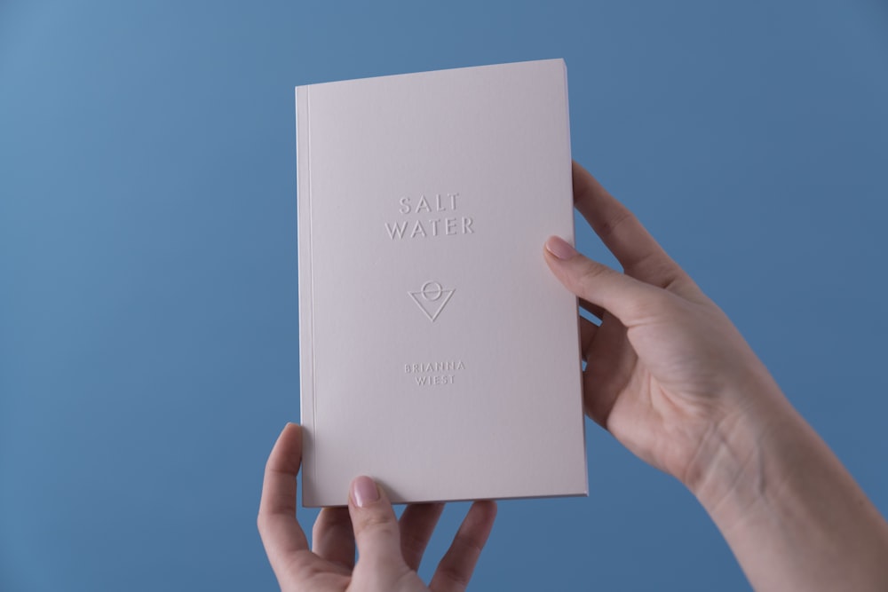 person holding Salt Water book
