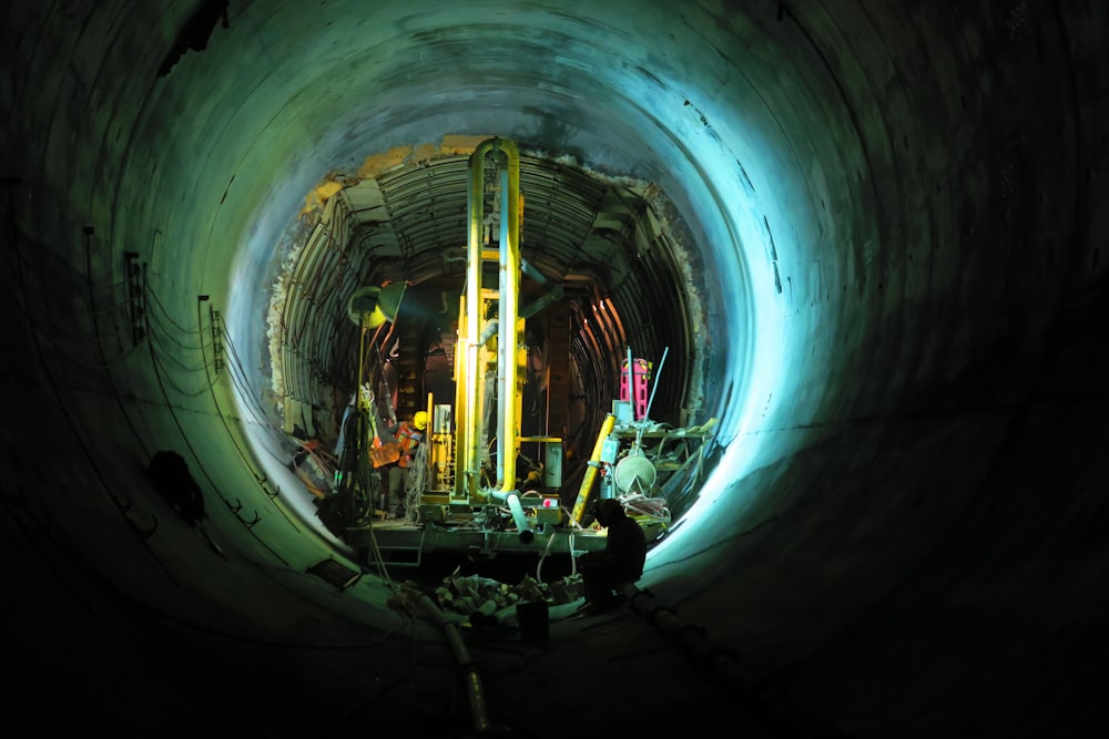 person sitting in tunnel near yellow turned on lamp