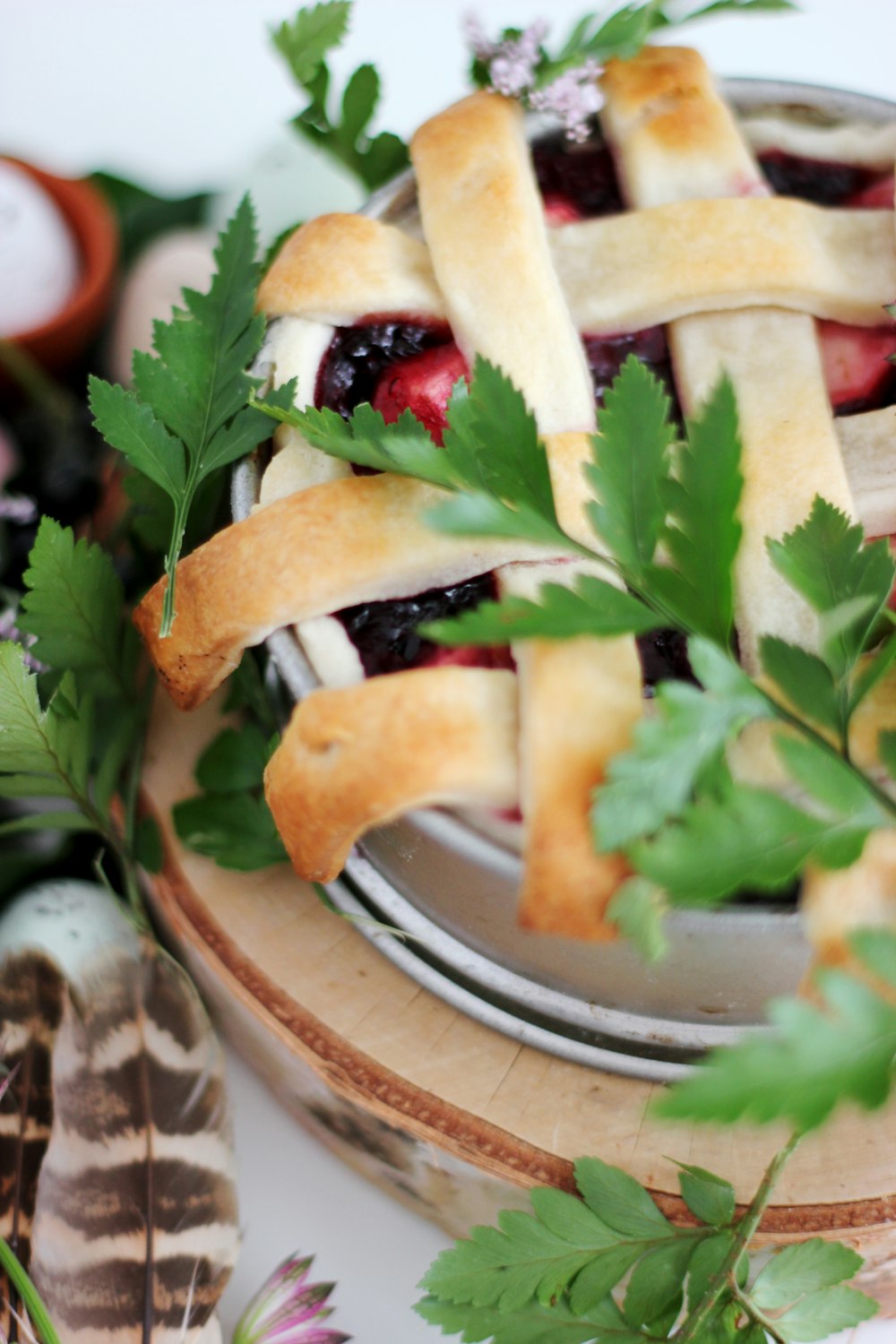 blueberry pie with parsley served on white ceramic bowl